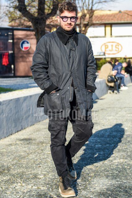 Men's fall/winter coordinate and outfit with plain black glasses, plain black field jacket/hunting jacket, plain gray turtleneck knit, dark gray plain cargo pants, and beige boots.