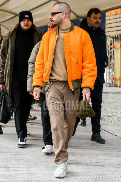 Men's winter/autumn coordinate and outfit with plain sunglasses, plain orange MA-1, plain beige turtleneck knit, plain beige slacks, and Adidas Yeezy Boost 500 white low-cut sneakers.