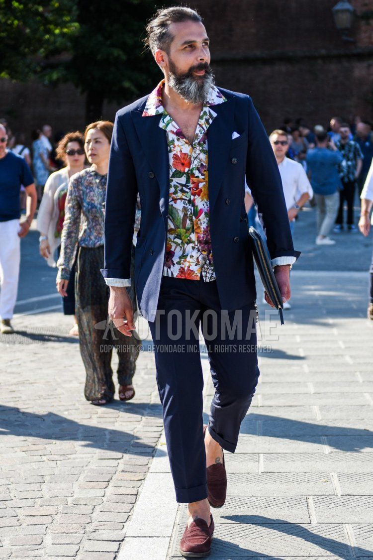 Men's coordinate and outfit with multi-colored botanical shirt, suede brown coin loafer leather shoes, and plain navy suit.