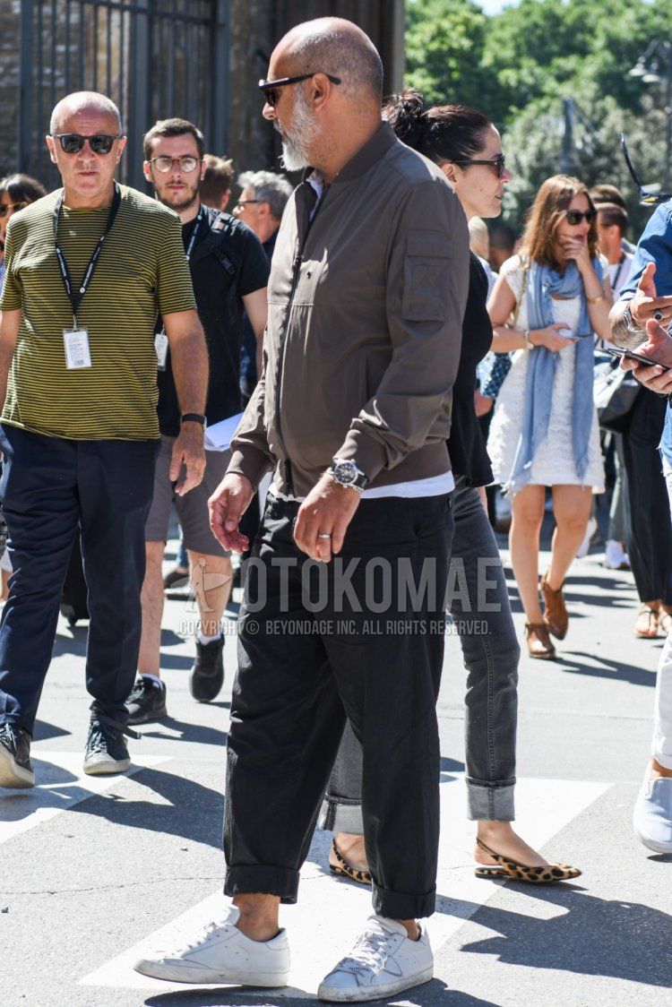 Men's coordinate and outfit with plain black sunglasses, plain gray MA-1, plain white shirt with band collar, plain gray slacks, and Philip model white low-cut sneakers.