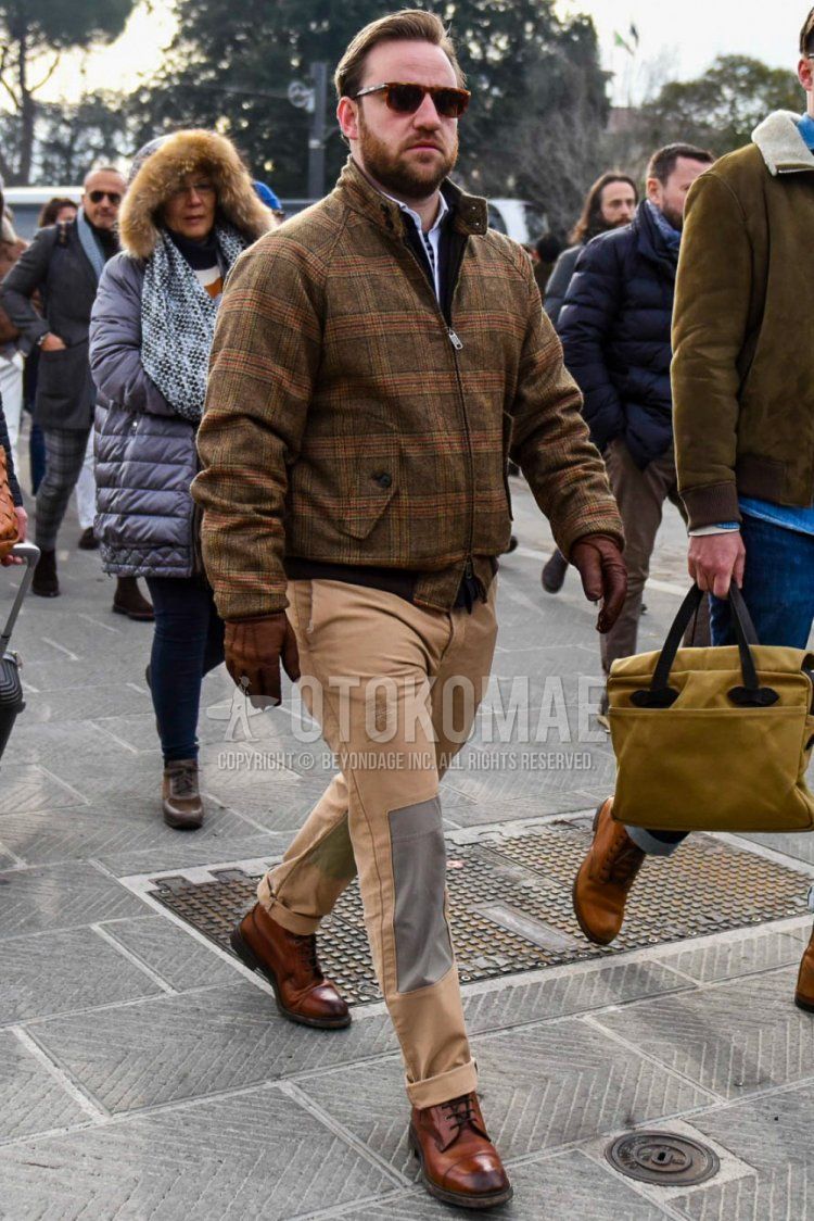 Men's coordinate and outfit with plain sunglasses, brown checked outerwear, plain brown chinos, and brown boots.
