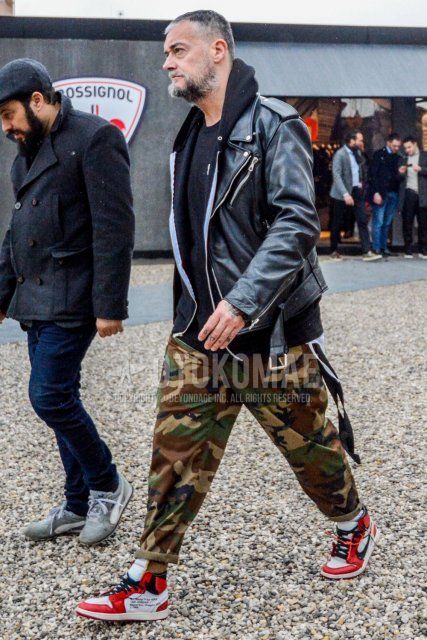Men's coordinate and outfit with plain black leather jacket (not riders), plain black hoodie, plain black sweater, multi-colored camouflage cotton pants, and Nike red and white high-cut sneakers.