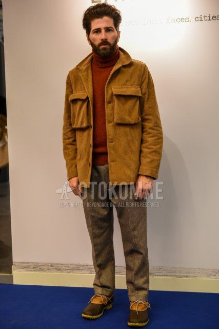 Men's fall/winter outfit with plain brown shirt jacket, plain brown turtleneck knit, plain gray slacks, and brown/beige leather shoes.