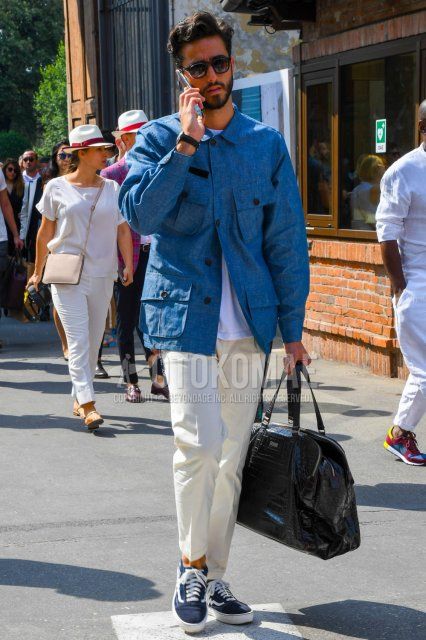 Men's spring/summer coordinate and outfit with plain black sunglasses, plain light blue shirt jacket, plain white t-shirt, plain white cotton pants, Vans Old School navy/black low-cut sneakers, and plain brown Boston bag.