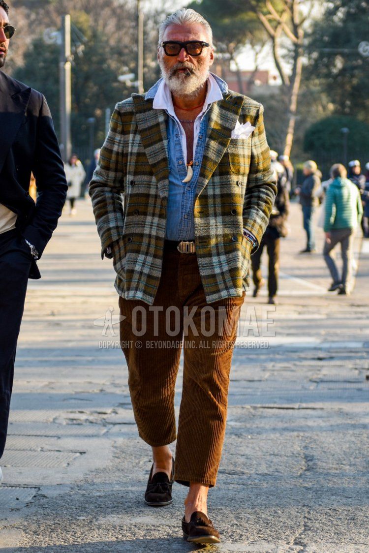 Solid black sunglasses, olive green checked tailored jacket, solid white shirt, solid blue denim/chambray shirt, solid brown leather belt, solid brown winter pants (corduroy, velour), solid brown cropped pants, suede Brown tassel loafer leather shoes for men in fall/winter.