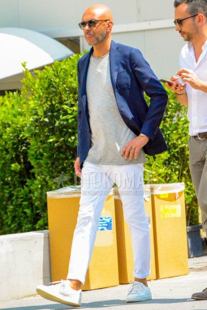 Men's coordinate and outfit with plain sunglasses, plain navy tailored jacket, plain gray t-shirt, plain white denim/jeans, and white low-cut sneakers.