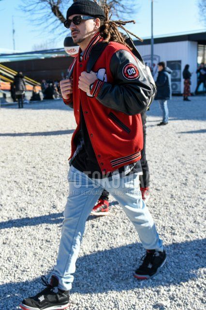 Men's fall/winter coordinate and outfit with plain black knit cap, plain black sunglasses, plain red/black stadium jacket, white/black checked shirt, plain black t-shirt, plain light blue pleated pants, and Nike Air Jordan 4 black high-cut sneakers.