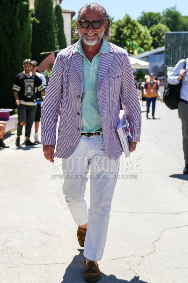 Men's spring, summer, and fall coordinate and outfit with Wellington brown tortoiseshell sunglasses, red striped tailored jacket, plain green polo shirt, plain black leather belt, plain white ankle pants, plain cotton pants, and suede brown tassel loafer leather shoes.