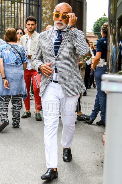 Men's spring, summer, and fall coordination and outfit with plain sunglasses, white and black checked tailored jacket, white striped shirt, plain black tape belt, plain white ankle pants, and black coin loafer leather shoes.