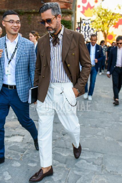 Men's spring/fall outfit with brown/blue tortoiseshell sunglasses, brown stole bandana/neckerchief, plain brown tailored jacket, white/brown striped shirt, plain white slacks, brown tassel loafer leather shoes.
