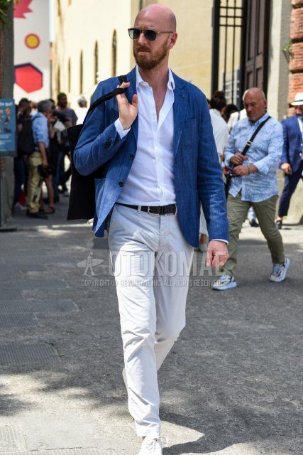 Men's spring, summer, and fall coordinate and outfit with plain gray tailored jacket, plain white shirt, plain black leather belt, plain beige cotton pants, and white low-cut sneakers.