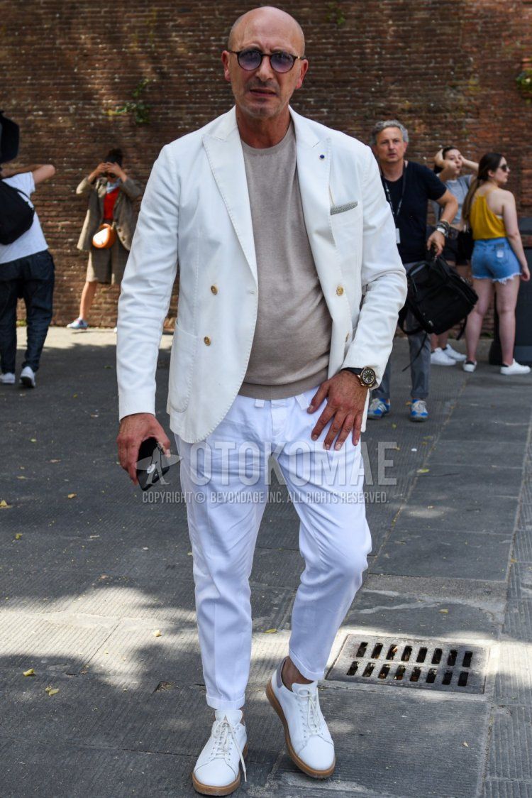 Men's spring, summer, and fall coordinate and outfit with plain black sunglasses, plain white tailored jacket, plain brown sweater, plain white cotton pants, and white low-cut sneakers from Boston.