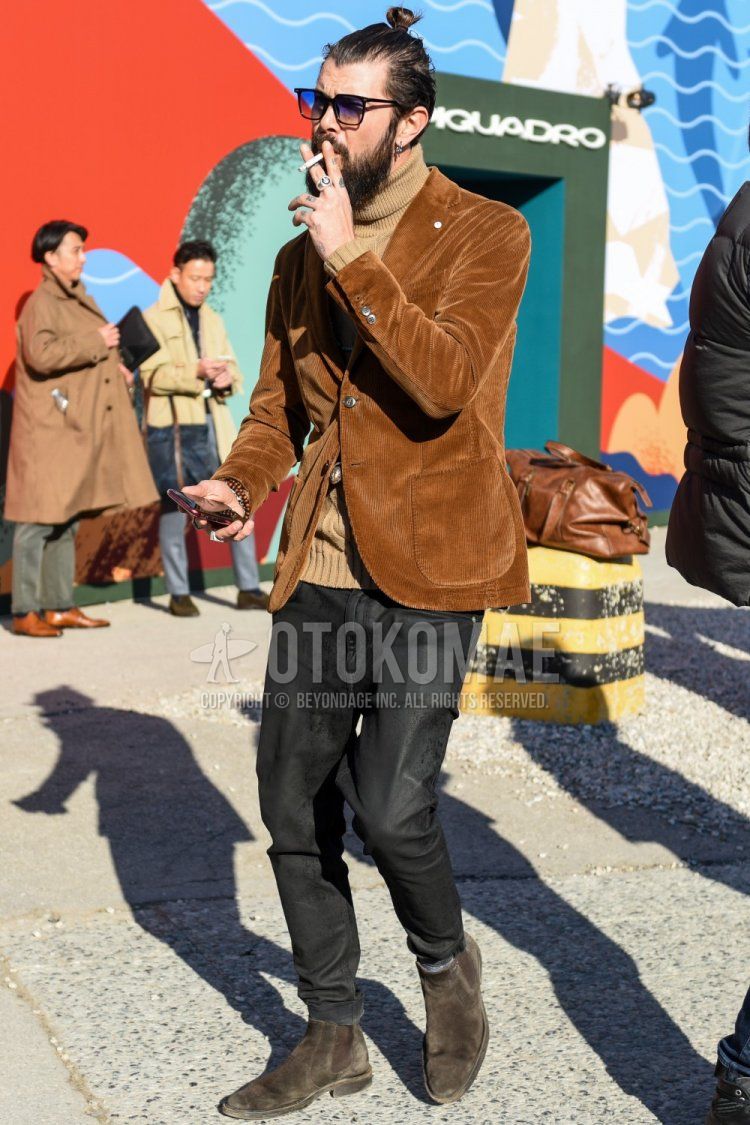 Men's spring/fall outfit with plain black Wellington sunglasses, plain brown tailored jacket, plain beige turtleneck knit, dark gray denim/jeans, and suede brown side gore boots.