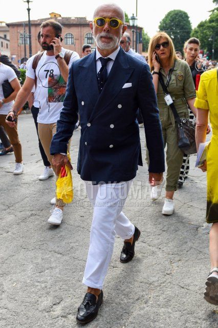 Spring and fall men's coordinate and outfit with plain yellow sunglasses, plain navy tailored jacket, plain white shirt, plain white cotton pants, black tassel loafer leather shoes, and navy-dot knit tie.