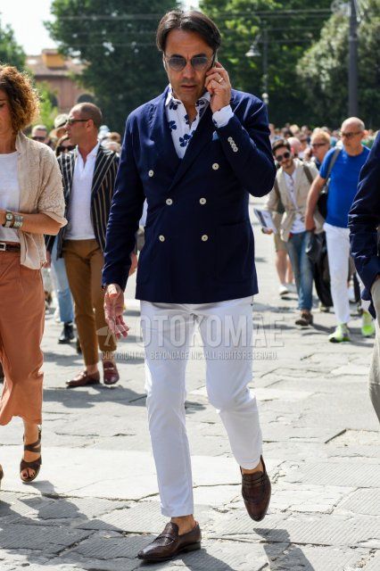 Men's spring, summer, and fall coordinate and outfit with plain gray sunglasses, plain navy tailored jacket, white botanical shirt, plain white cotton pants, plain ankle pants, and brown coin loafer leather shoes.