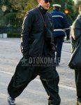 Men's fall/winter coordinate and outfit with plain black sunglasses, plain black outerwear, plain black jogger pants/ribbed pants, Asics silver low-cut sneakers, and a plain black sacosh.