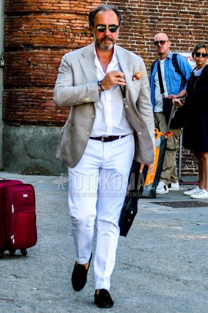 Men's spring, summer, and fall coordinate and outfit with solid color sunglasses, solid color beige tailored jacket, solid color white shirt, solid color white slacks, and navy coin loafer leather shoes.
