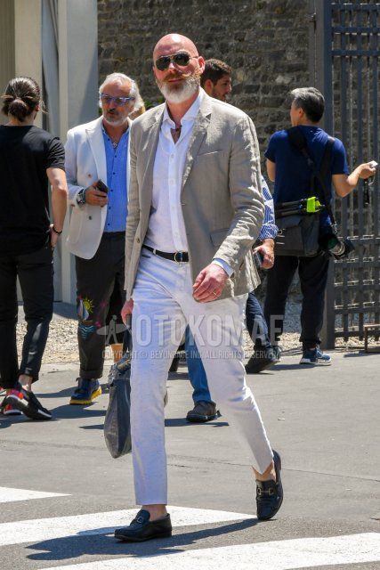 Men's spring, summer, and fall coordinate and outfit with solid color sunglasses, solid color beige tailored jacket, solid color white shirt, solid color black leather belt, solid color white ankle pants, and black bit loafer leather shoes.