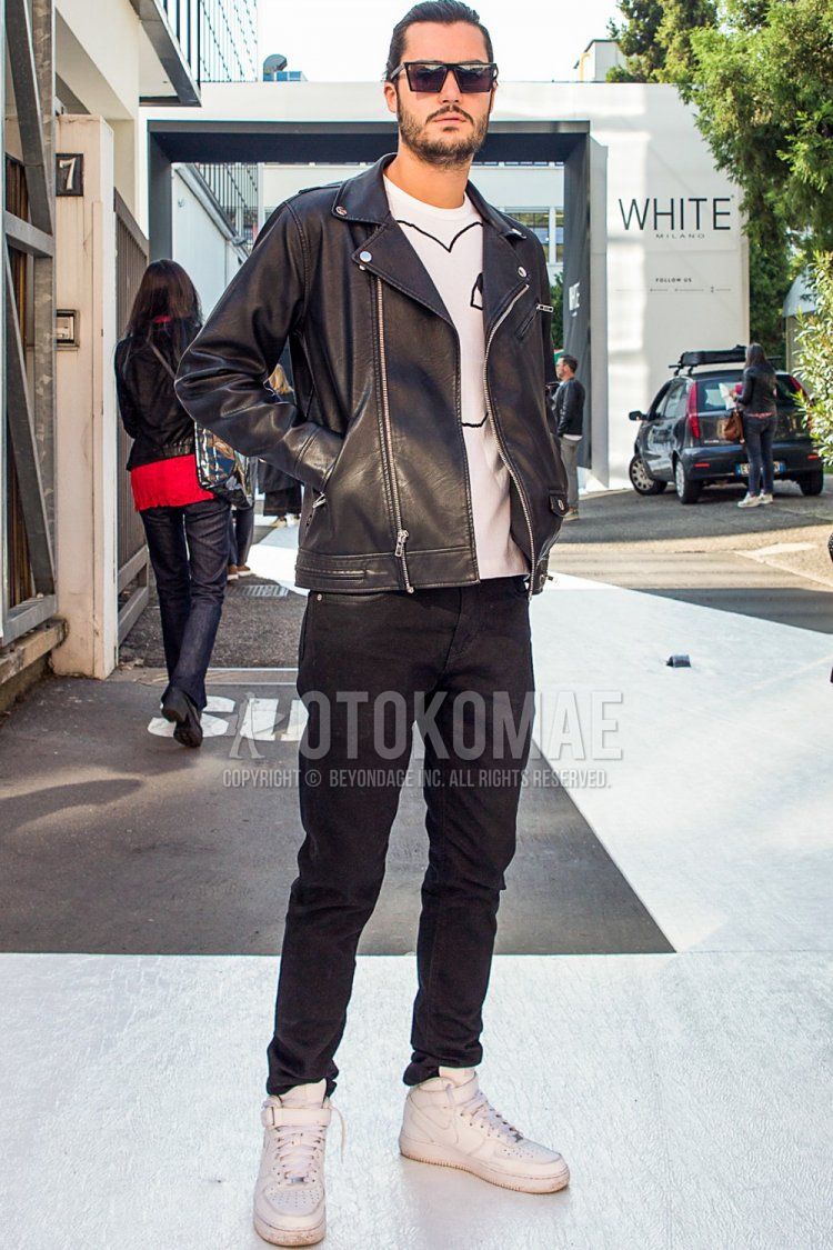 Men's spring/autumn coordinate and outfit with plain black sunglasses, plain black rider's jacket, Play Comme des Garcons white graphic t-shirt, plain black denim/jeans, and Nike Air Force One white high-cut sneakers.
