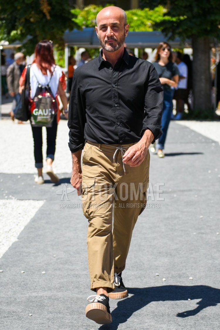 Men's spring, summer, and fall coordinate and outfit with plain black shirt, plain beige cargo pants, plain beige easy pants, and black high-cut sneakers.