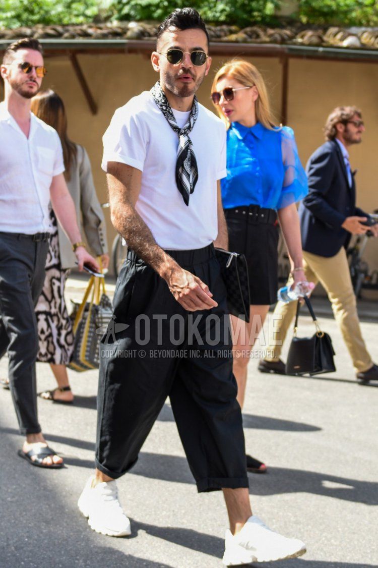 A summer men's coordinate and outfit with round black and gold plain sunglasses, black stole bandana/neckerchief, plain white t-shirt, plain black easy pants, and white low-cut sneakers.