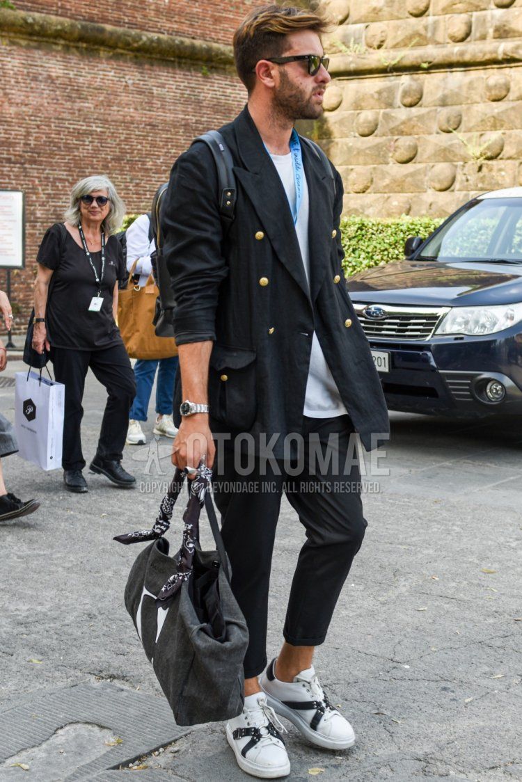 Men's spring, summer, and fall coordinate and outfit with plain Wellington sunglasses, plain black tailored jacket, plain white t-shirt, plain black ankle pants, white low-cut sneakers, and dark gray solid color Boston bag.
