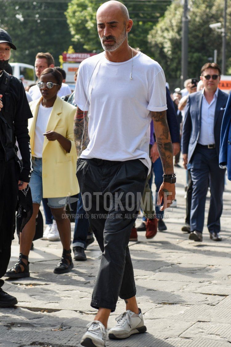 Men's summer coordinate and outfit with plain white T-shirt, plain gray cotton pants, and white low-cut sneakers.