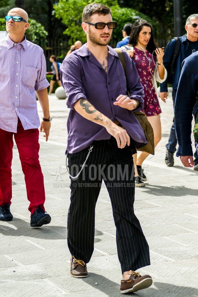 Men's spring/summer/autumn coordination and outfit with plain sunglasses, plain purple shirt, wide black striped pants, and brown moccasins/deck shoes leather shoes.