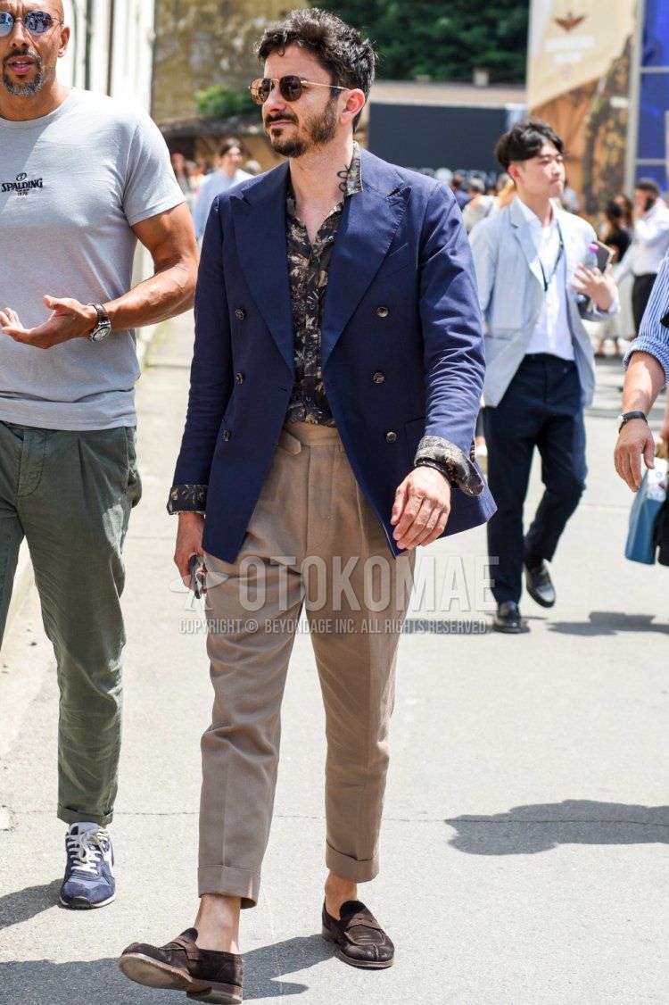 Men's spring, summer, and fall coordination and outfit with plain silver/black sunglasses, plain navy tailored jacket, black top/inner shirt, plain beige beltless pants, and brown coin loafer leather shoes.