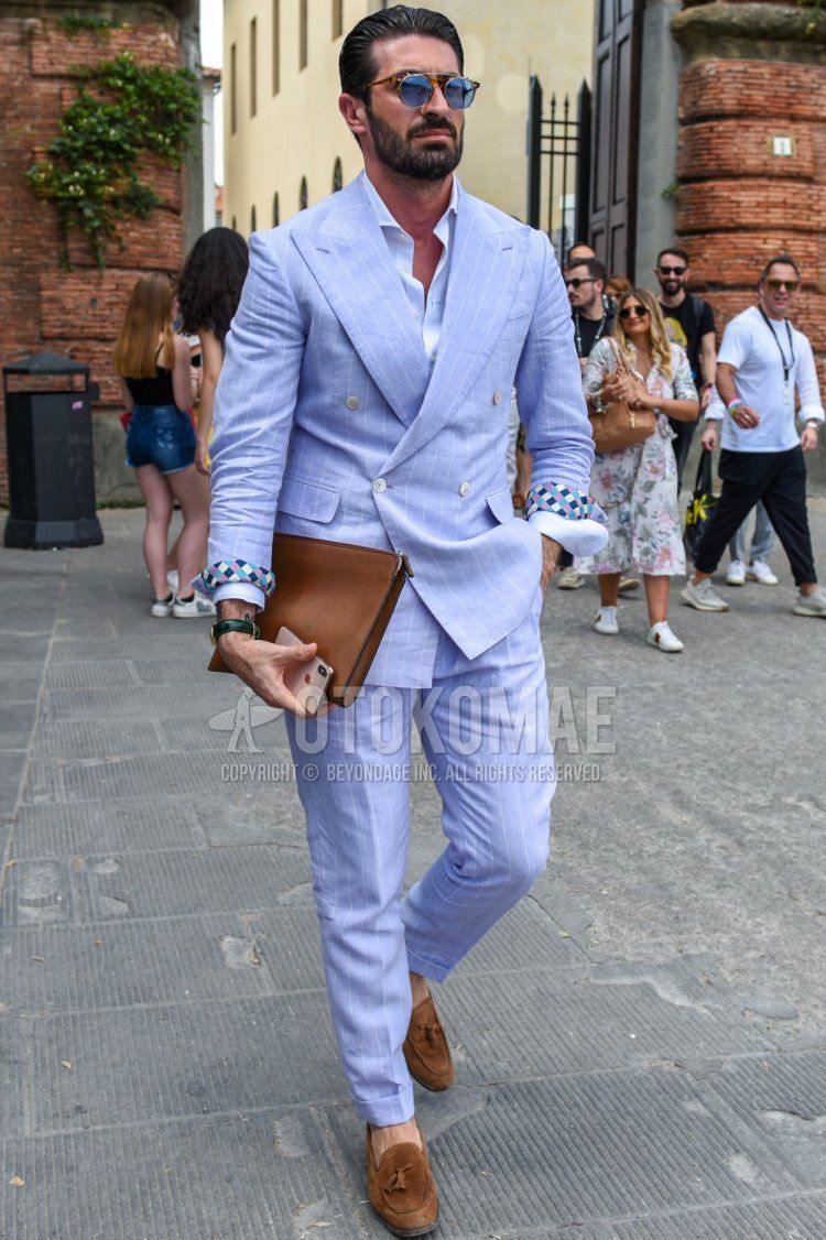 Men's spring/summer/fall coordination and outfit with brown/blue tortoiseshell sunglasses, plain white shirt, brown tassel loafer leather shoes, plain brown clutch bag/second bag/drawstring, light blue striped suit.