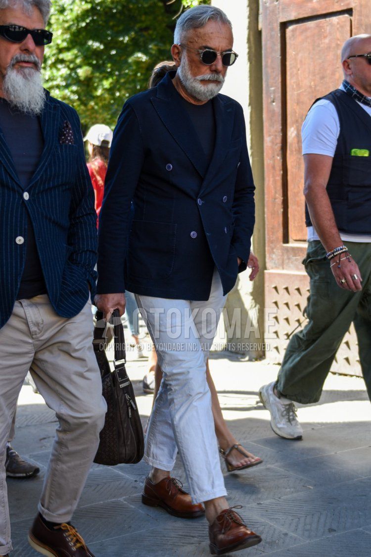 Men's spring/summer coordinate and outfit with plain silver/black sunglasses, plain navy tailored jacket, plain navy t-shirt, plain white cotton pants, plain ankle pants, brown plain toe leather shoes, and plain brown shoulder bag.