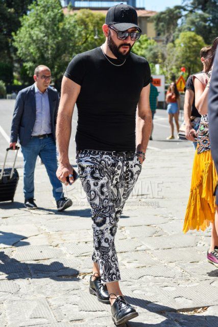 Summer men's coordinate and outfit with plain black baseball cap, plain black sunglasses, plain black t-shirt, plain black leather belt, white/black bottoms cotton pants, and black plain toe leather shoes.