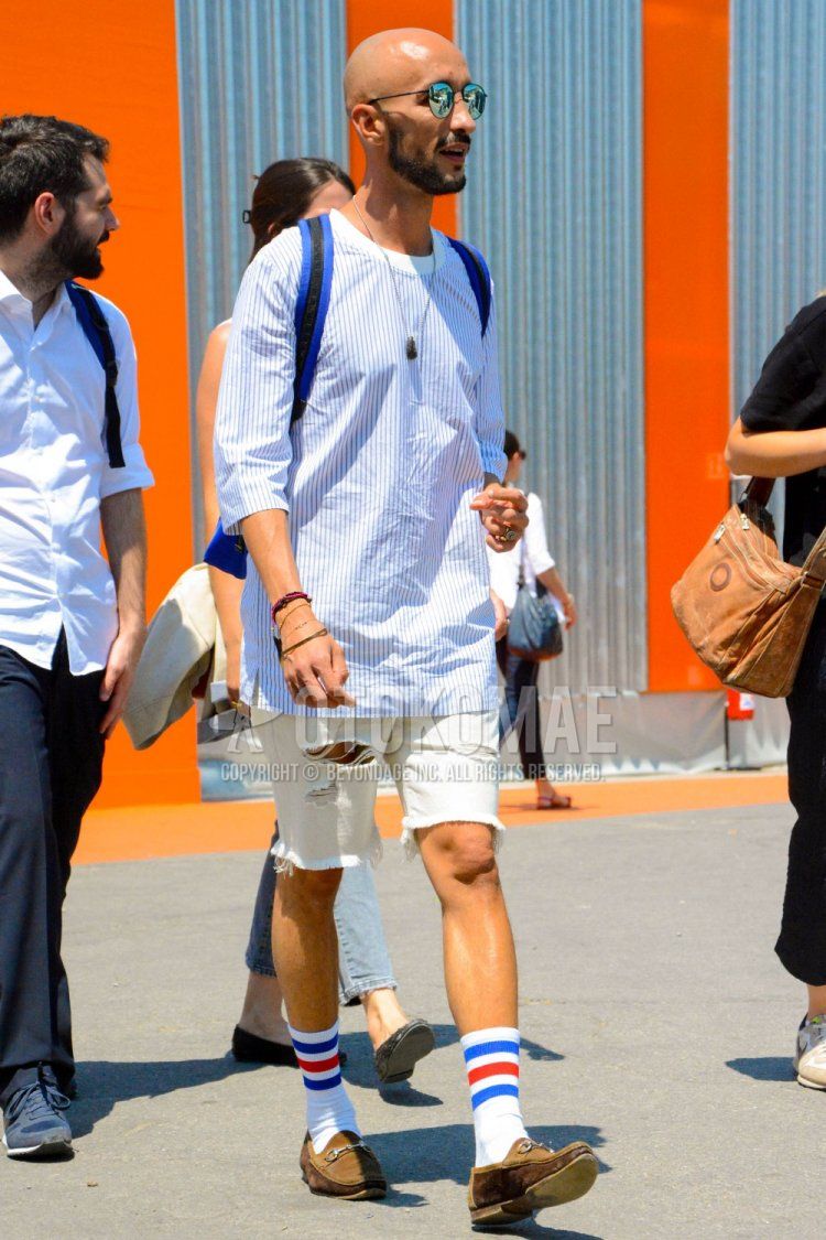 Men's spring, summer, and fall coordination and outfit with plain sunglasses, white striped long T, plain white shorts, white striped socks, brown bit loafers leather shoes, and brown suede shoes leather shoes.