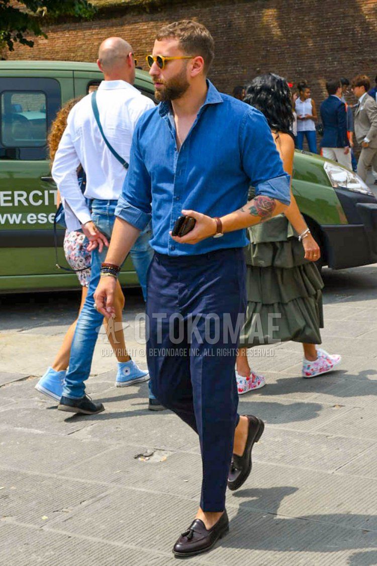 Men's spring and summer coordinate and outfit with plain sunglasses, plain blue shirt, plain navy beltless pants, plain slacks, and brown tassel loafer leather shoes.