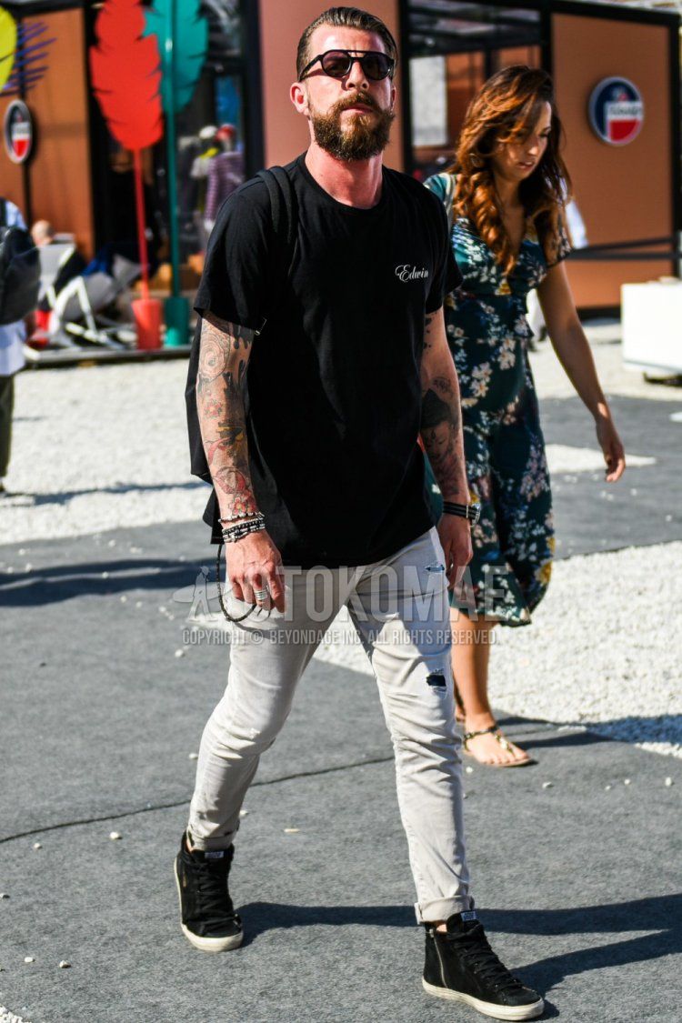 A summer men's coordinate and outfit with plain black sunglasses, a plain black T-shirt, plain gray damaged jeans, and high-cut sneakers.