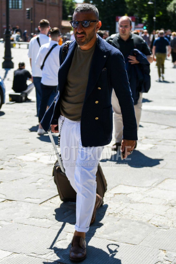 Men's spring, summer, and fall coordinate and outfit with plain black sunglasses, plain navy tailored jacket, plain olive green t-shirt, plain white cotton pants, and brown brogue shoes leather shoes.