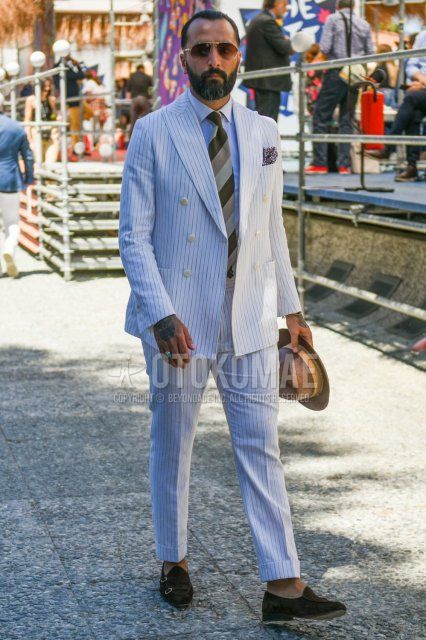 Men's spring/summer/autumn coordinate and outfit with plain brown hat, plain gold sunglasses, plain white shirt, brown monk shoes leather shoes, white striped suit and brown striped tie.