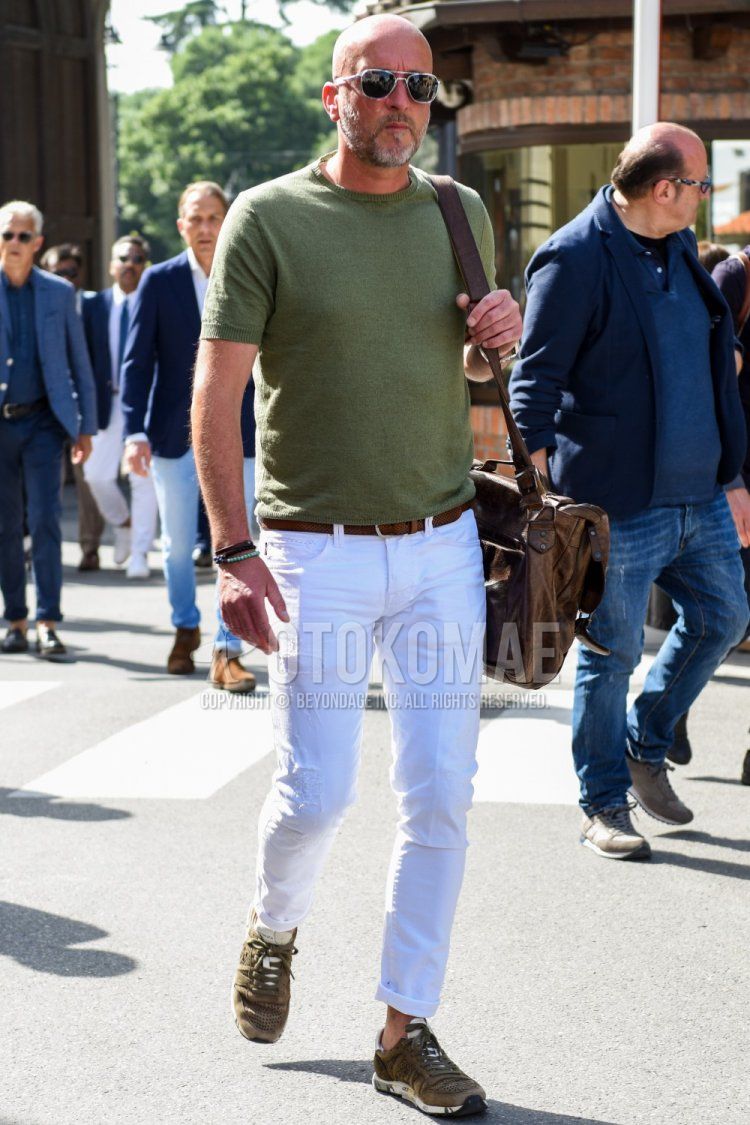 Men's spring/summer coordinate and outfit with plain black/silver sunglasses, knit plain green t-shirt, plain brown leather belt, plain white damaged jeans, olive green low-cut sneakers, and plain brown shoulder bag.