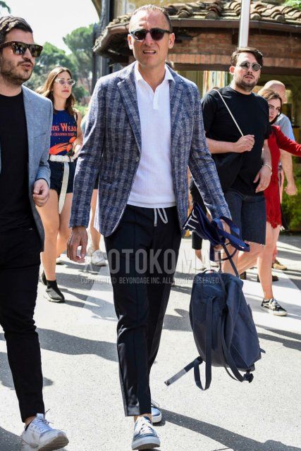 Men's spring/summer coordinate and outfit with clear plain sunglasses, gray checked tailored jacket, plain white polo shirt, dark gray plain easy pants, plain ankle pants, and navy low-cut sneakers.