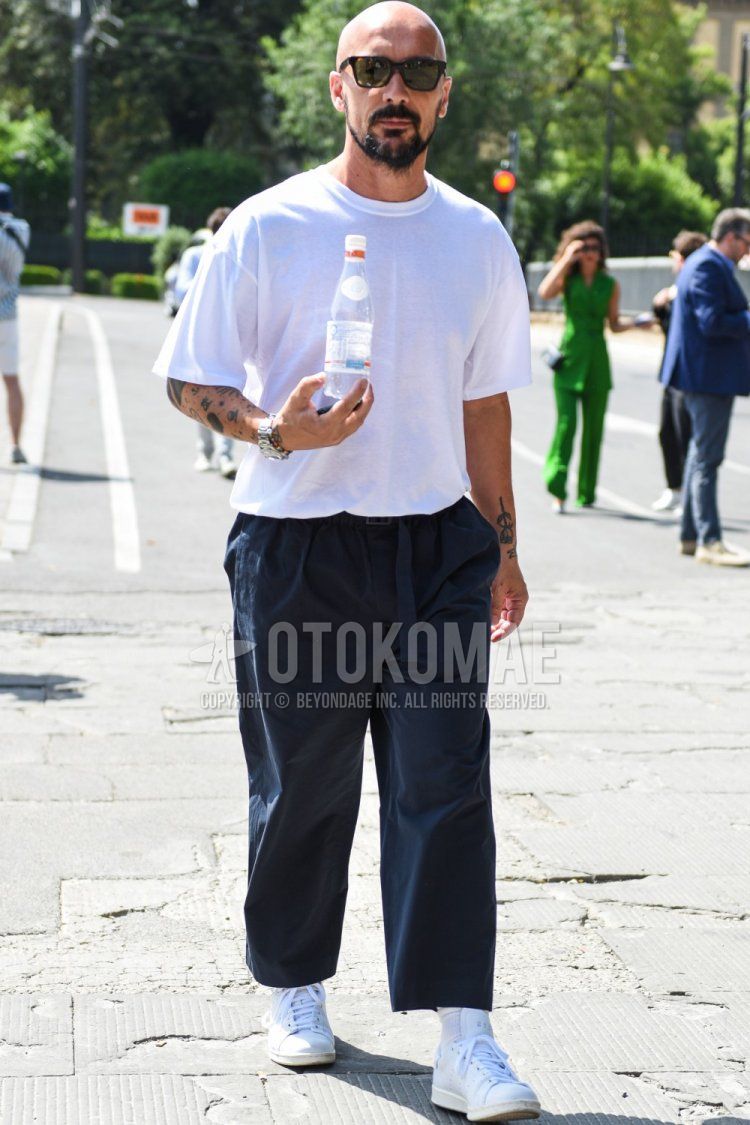 Men's summer coordinate and outfit with plain black sunglasses, plain white T-shirt, plain navy wide pants, plain white socks, and white low-cut sneakers.