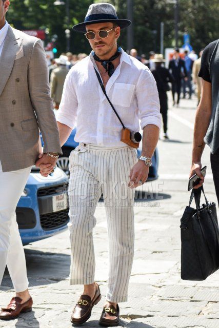 Men's spring/summer/fall outfit with plain gray hat, solid gold sunglasses, solid blue bandana/neckerchief, plain white linen shirt, white striped beltless pants, brown bit loafer leather shoes.
