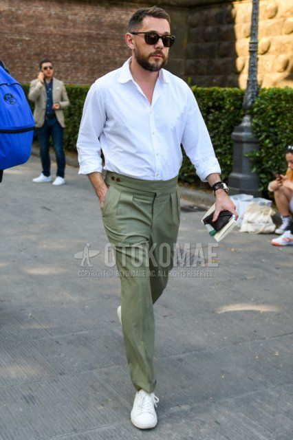 Men's spring/summer coordinate and outfit with plain black sunglasses, plain white shirt, plain olive green beltless pants, plain pleated pants, and white low-cut sneakers.
