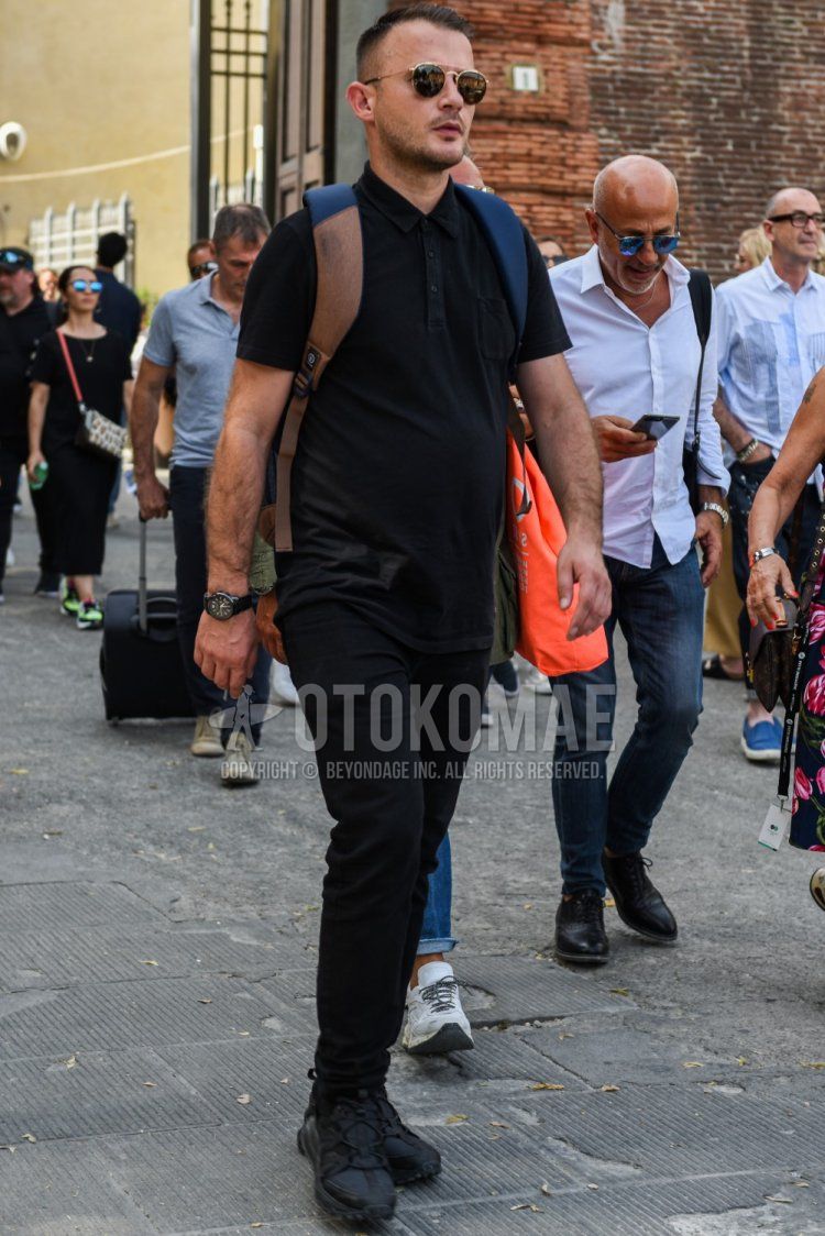 Men's spring and summer coordinate and outfit with Ray-Ban gold solid color sunglasses, solid color black polo shirt, solid color black cotton pants, and Nike Air Max 270 Bowfin dark gray low-cut sneakers.