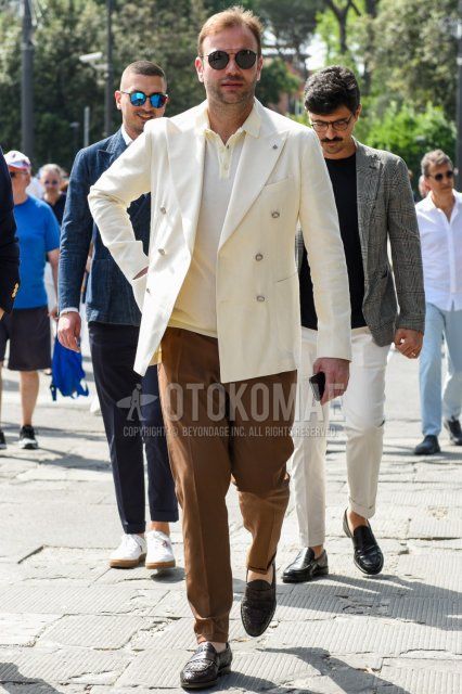 Men's spring, summer, and fall coordinate and outfit with plain black sunglasses, plain white tailored jacket, knit plain white polo shirt, plain brown slacks, plain brown pleated pants, and brown coin loafer leather shoes.