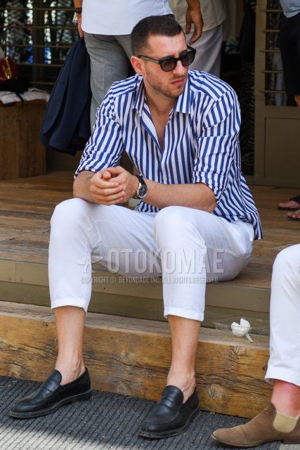 Men's spring/summer coordinate and outfit with plain black sunglasses, white/blue striped shirt, plain white cotton pants, and black coin loafer leather shoes.