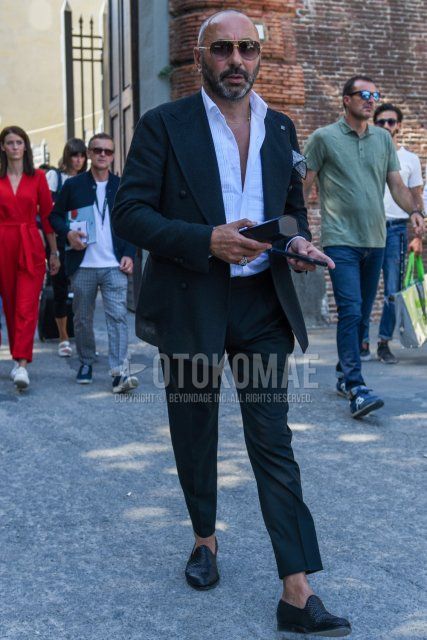 Men's spring, summer, and fall coordination and outfit with teardrop gold plain sunglasses, plain white shirt, black leather shoes, and plain black suit.
