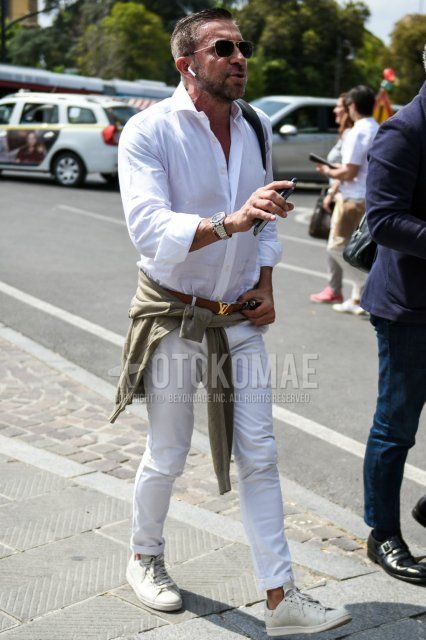 Men's spring/summer outfit with plain black/gold sunglasses, plain white shirt, plain brown leather belt from Louis Vuitton, plain white cotton pants, and Adidas Raf Simons Stan Smith white low-cut sneakers.
