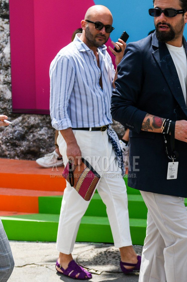 Men's spring/summer coordinate and outfit with plain black sunglasses, light blue striped shirt, plain black leather belt, plain white cropped pants, plain white cotton pants, and suede purple Gurkha sandals.