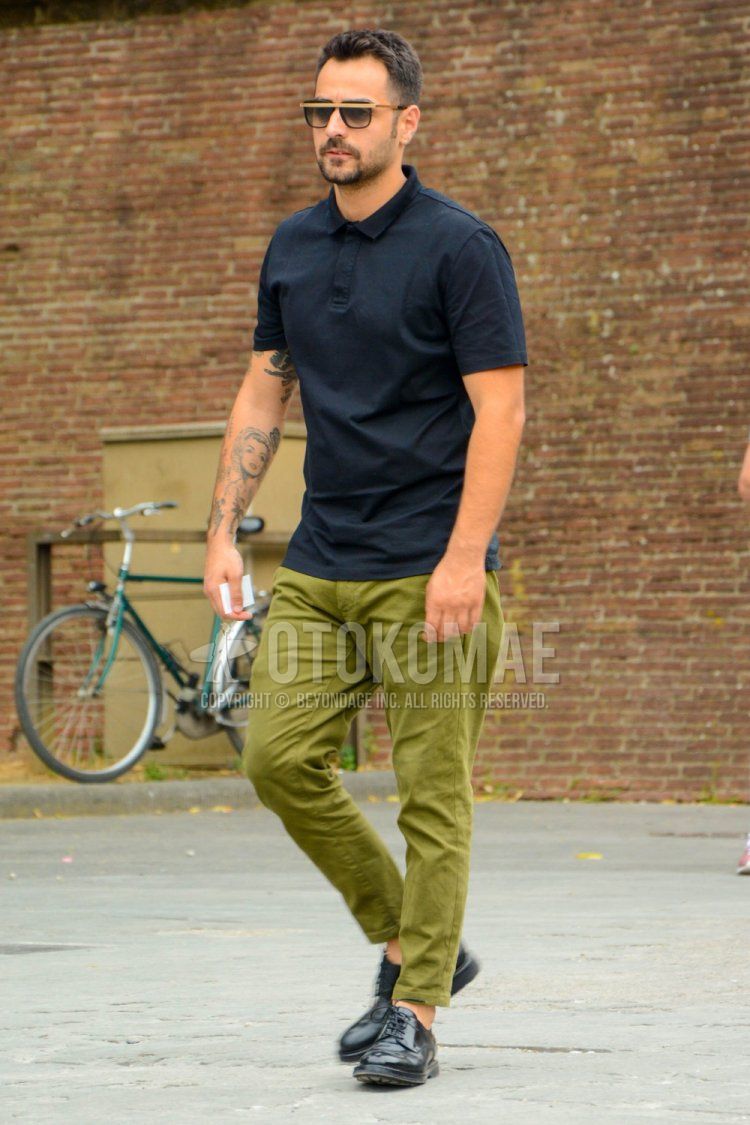 Men's spring and summer coordinate and outfit with plain sunglasses, plain black polo shirt, plain olive green chinos, and black plain toe leather shoes.