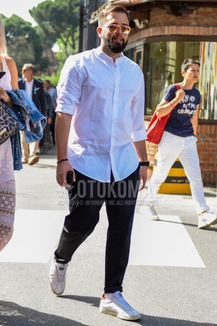 Men's spring/summer coordinate and outfit with plain gold sunglasses, plain white shirt with band collar, plain black cotton pants, plain white socks, and white low-cut sneakers.